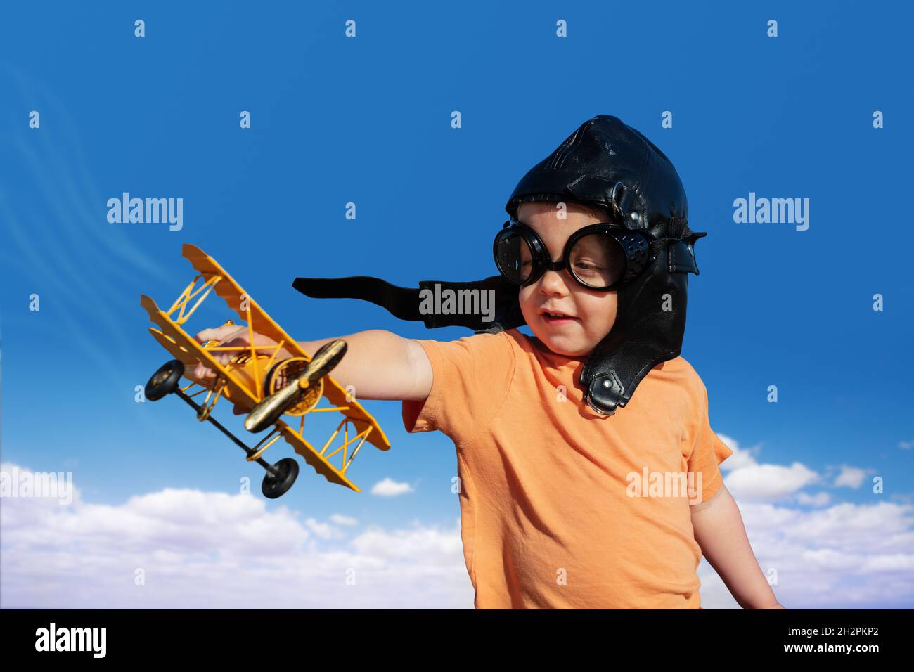 Boy with toy model of a plane wearing aviation hat Stock Photo Alamy