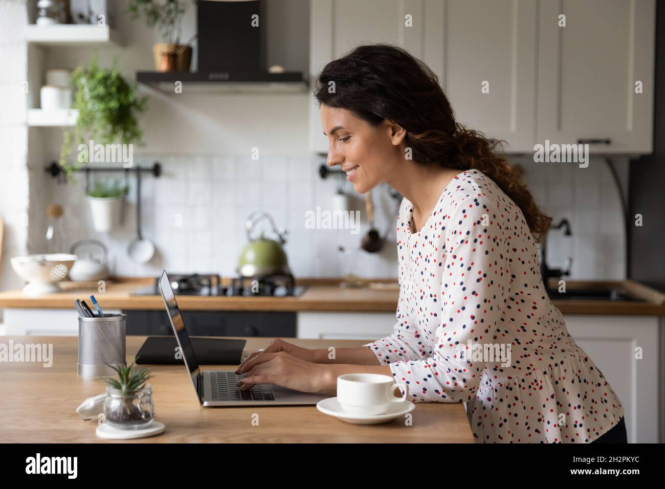 Happy freelance woman working at computer from home Stock Photo