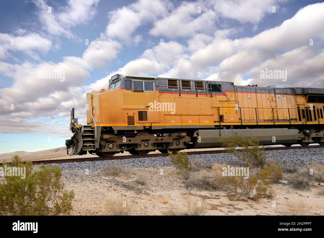 Freight train engine travelling through the Mojave desert Stock Photo