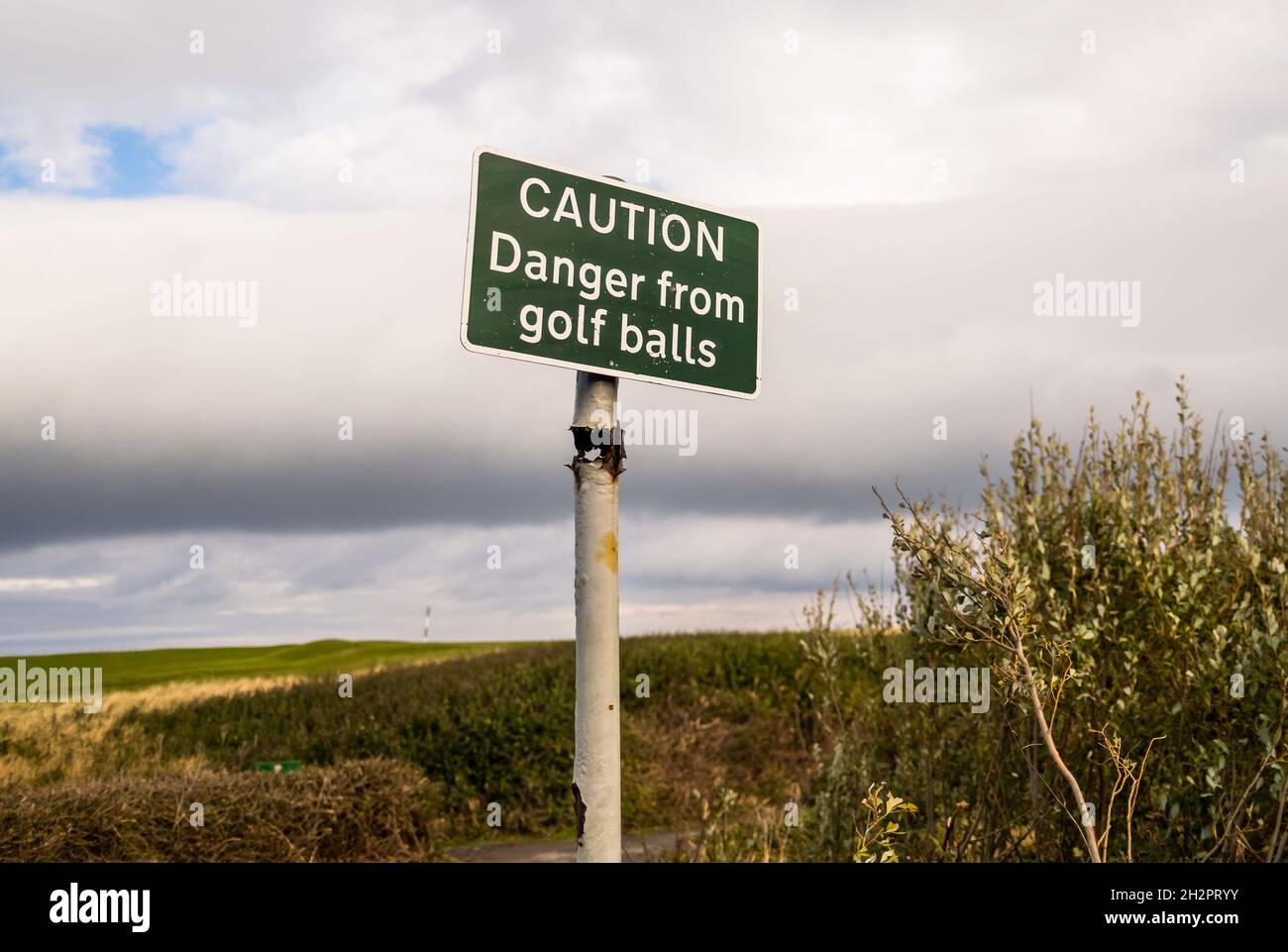 Caution sign of “Danger from golf balls” on the Cleveland coastal path