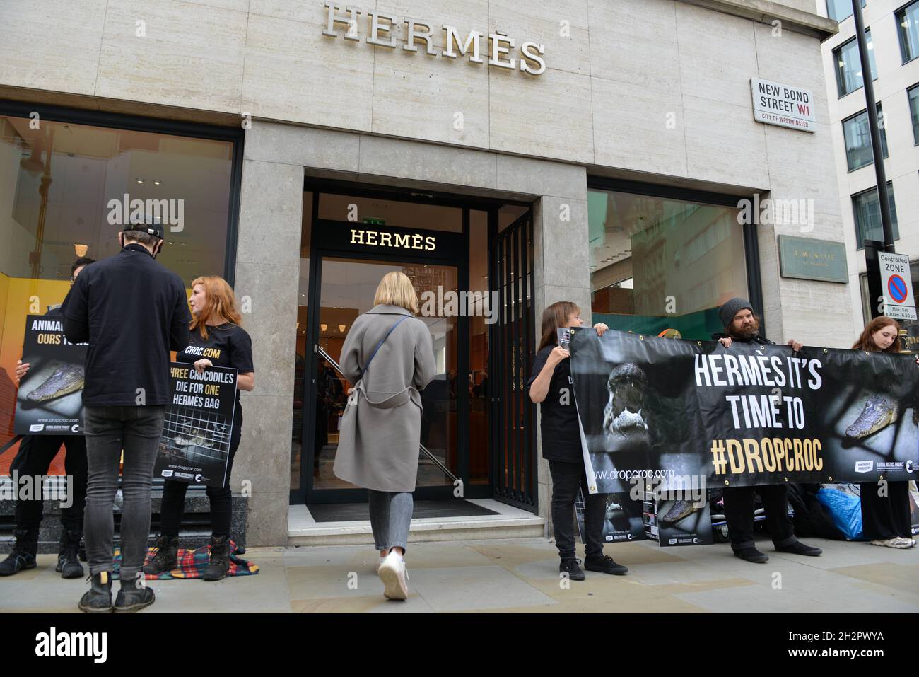 London, UK. 28th May 2022. Animal rights activists gathered outside the  Hermes store in Bond Street in protest against the use of crocodile and  other animal skins in the fashion brand's products.
