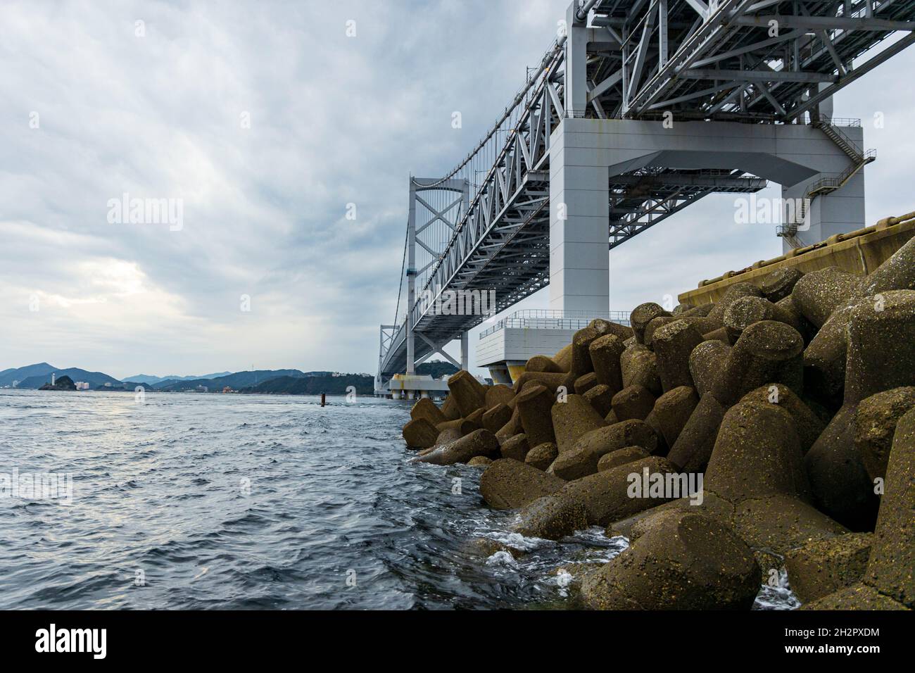 Concrete tetrapods under suspension bridge across Naruto Straight between Awaji and Tokushima Stock Photo