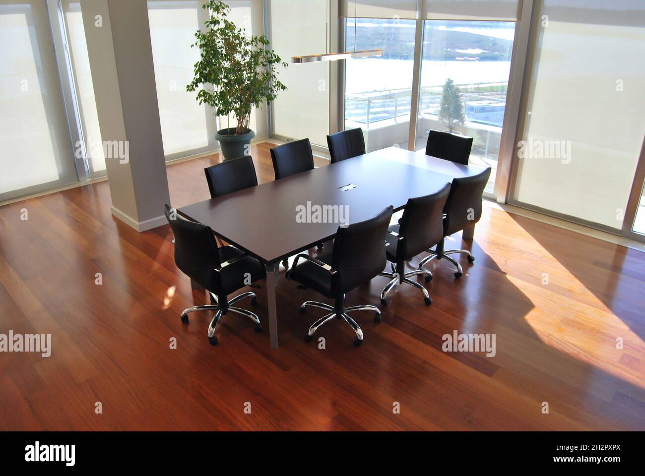 Empty meeting table and chairs in a modern conference room. Business