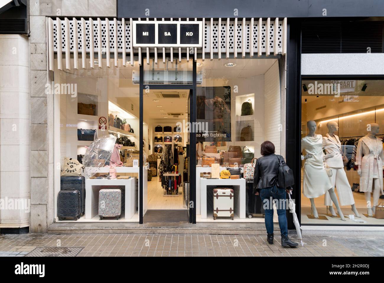 A woman looks at the shop window of Misako accessories store in Valencia. Photo by Xisco Navarro SOPA Images Sipa USA Stock Photo Alamy