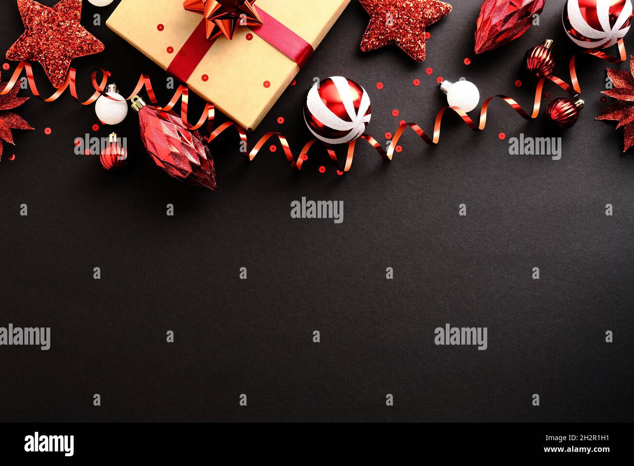 Elegant Black Christmas background with gift box, red stars, striped  baubles, confetti. Flat lay. Christmas Frame top border. Happy New Year  postcard Stock Photo - Alamy