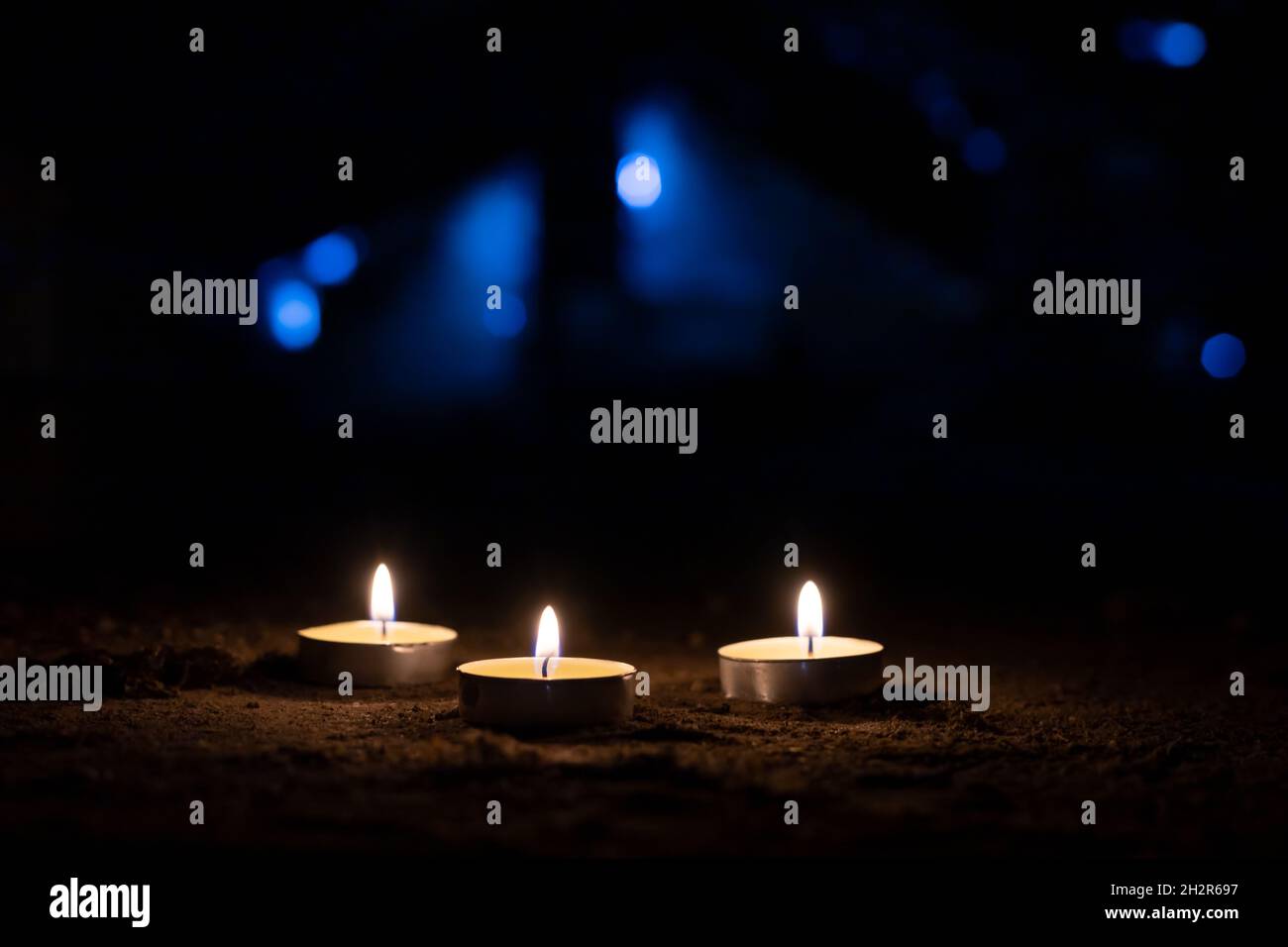 Three burning candles with dark background. Copy space Stock Photo - Alamy