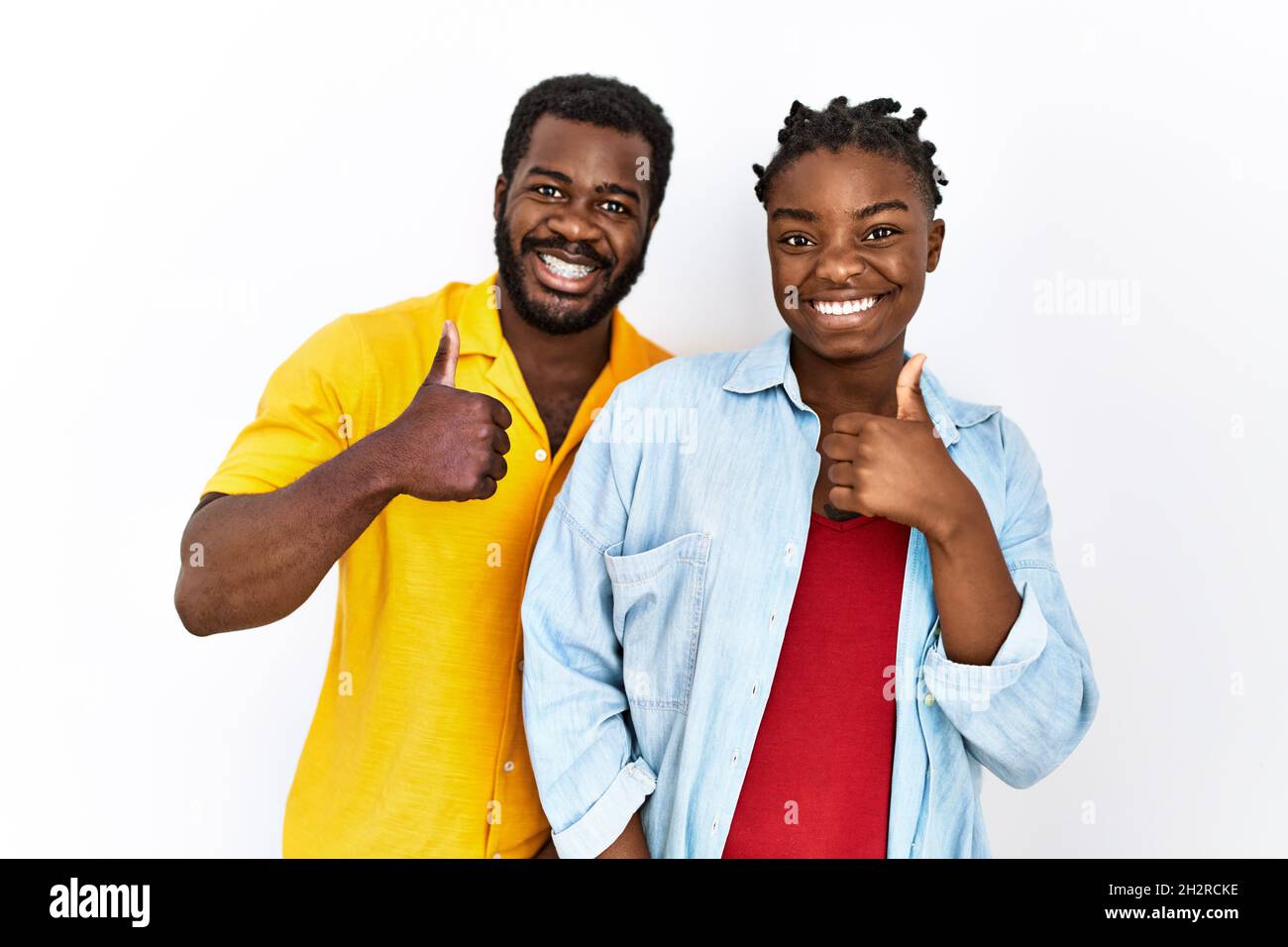 Young african american couple wearing casual clothes doing happy thumbs ...