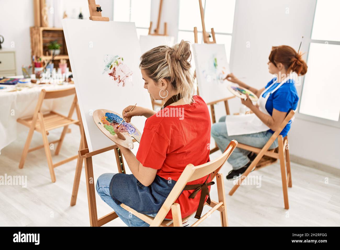 Two girls painting on easel hi-res stock photography and images - Alamy