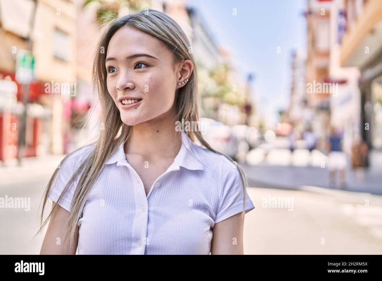 Young chinese girl smiling happy standing at the city Stock Photo Alamy