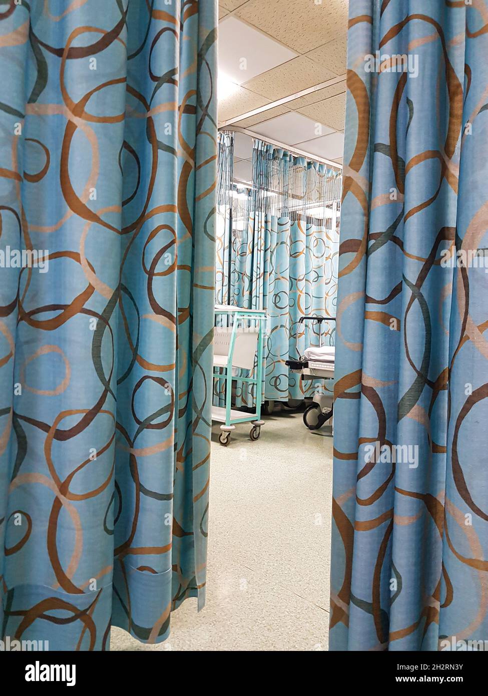 Medical facility beds and curtains in ward ready for patients, in