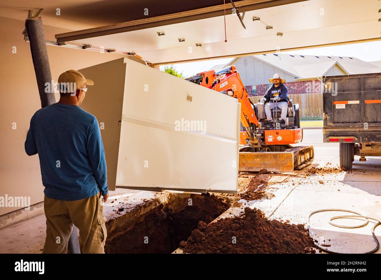 https://c8.alamy.com/comp/2H2RNH2/oklahoma-oct-19-2021-worker-was-working-on-a-garage-underground-storm-shelter-installation-2H2RNH2.jpg