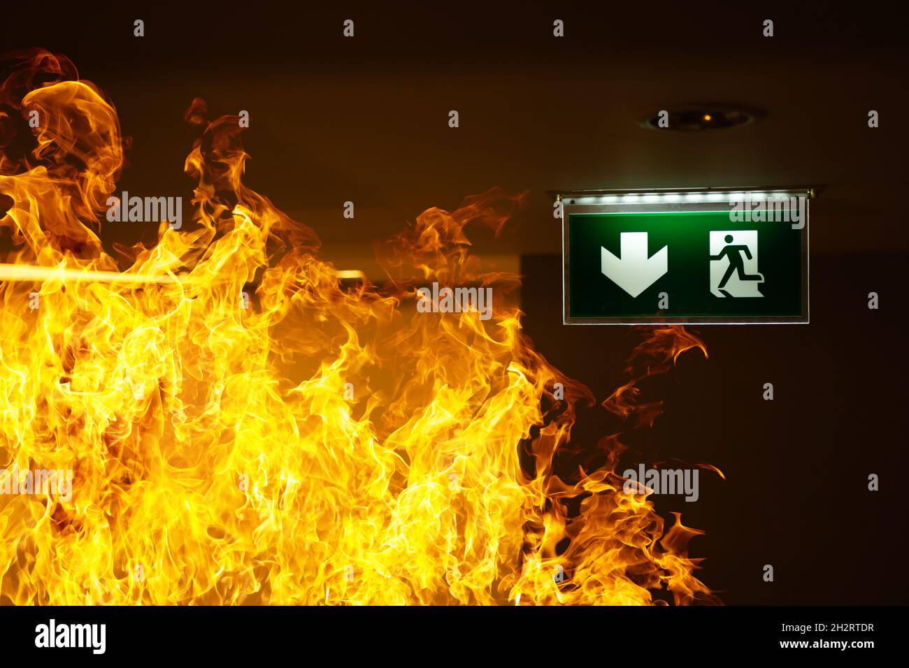 Green fire escape sign hang on the ceiling in the Warehouse. The