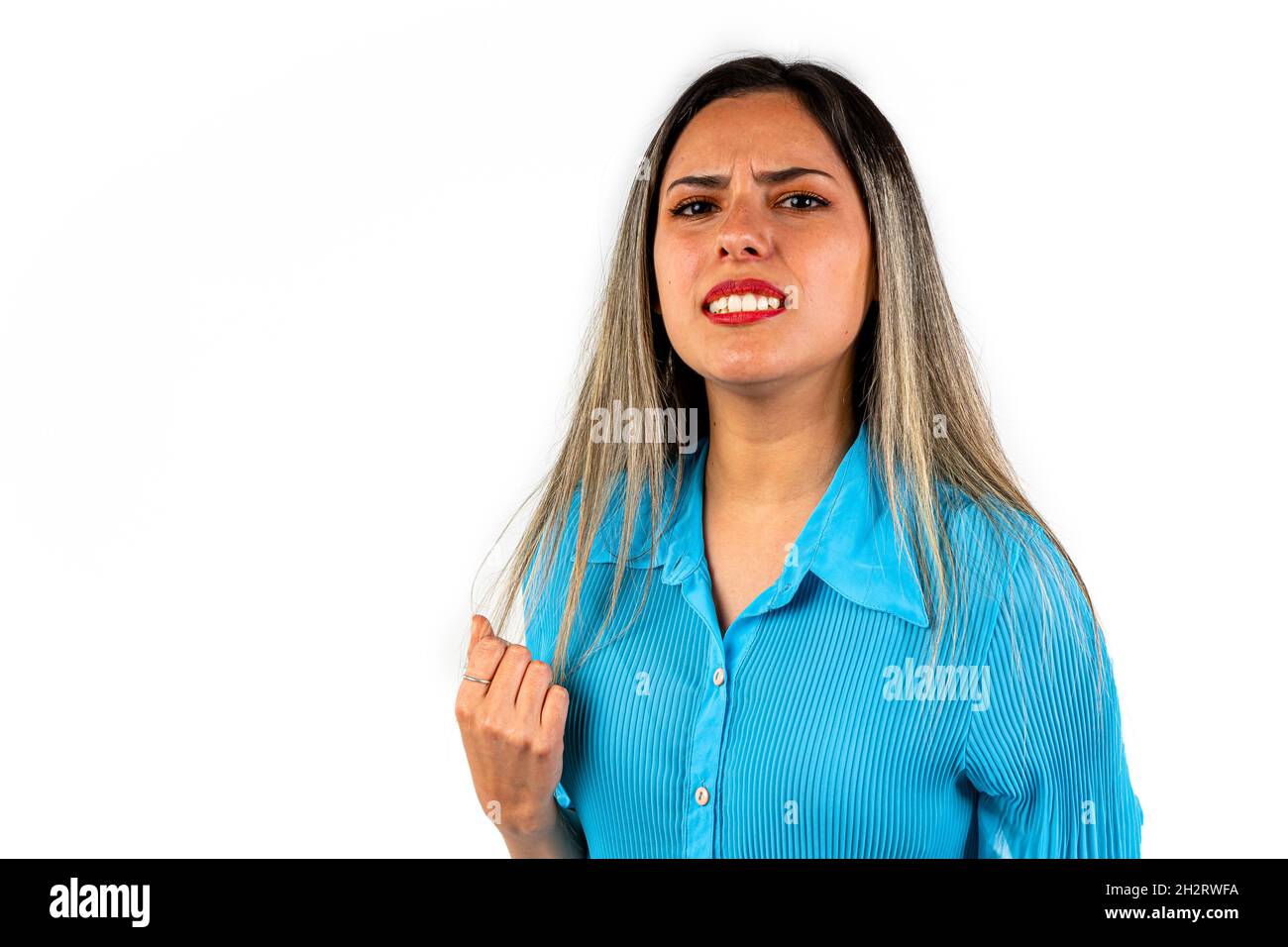 A Beautiful young woman with an expression of frustration, helplessness and sadness and with a clenched fist. Stock Photo