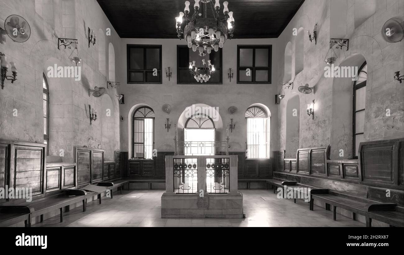 Black and white shot of interior of historic Jewish Maimonides Synagogue or Rav Moshe Synagogue with altar, arched windows and chandelier in Gamalia district, Cairo Egypt Stock Photo