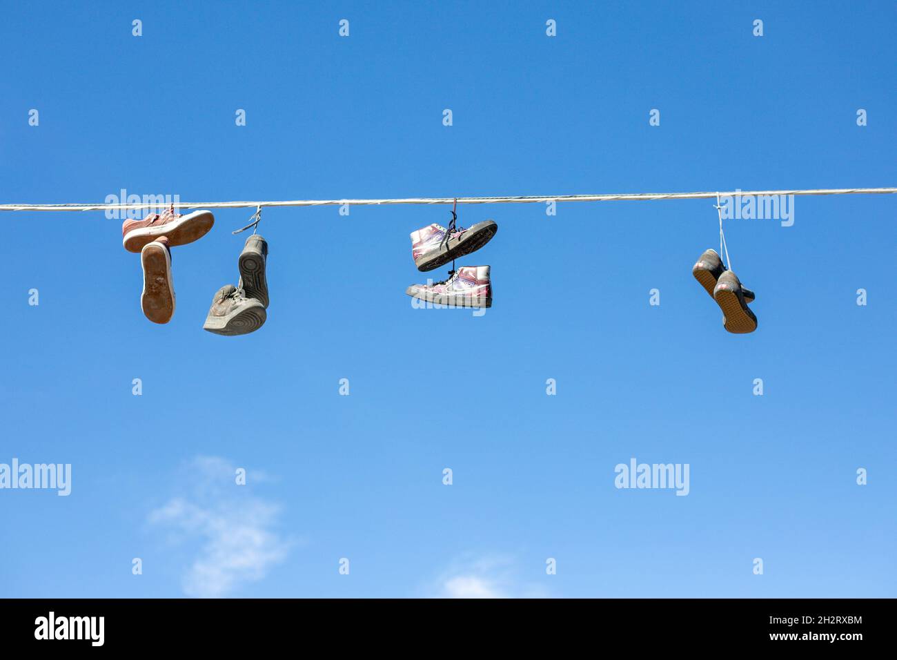 Shoes hanging from wires Stock Photo Alamy
