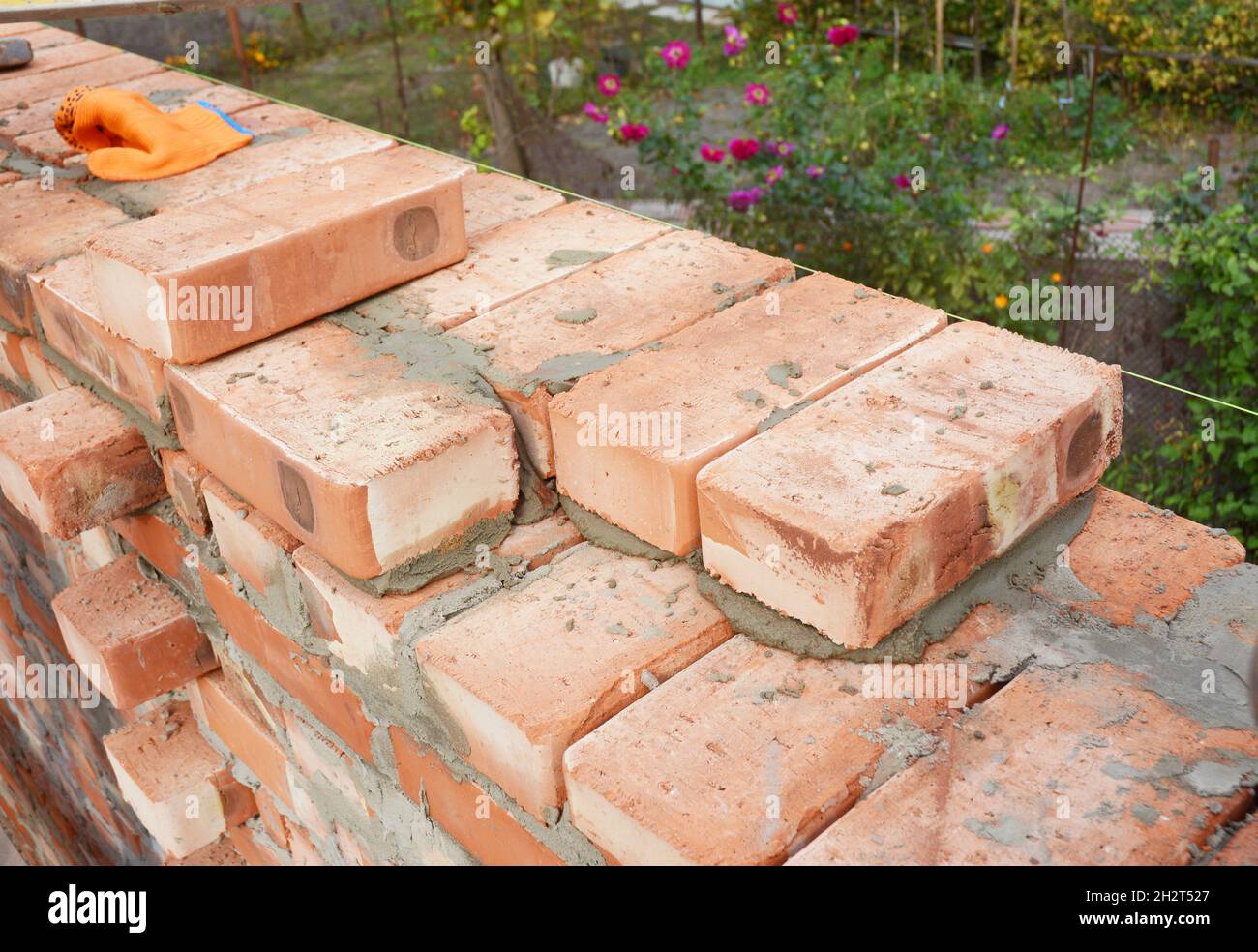 Bricklaying, Brickwork. Bricklaying on House Construction Site. Building Home wall from Bricks. Stock Photo