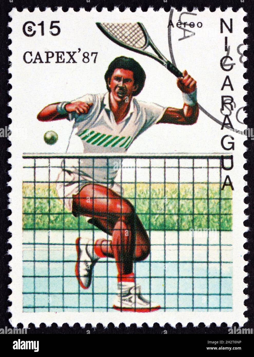 NICARAGUA - CIRCA 1987: a stamp printed in Nicaragua shows Male Tennis Player in Action, circa 1987 Stock Photo