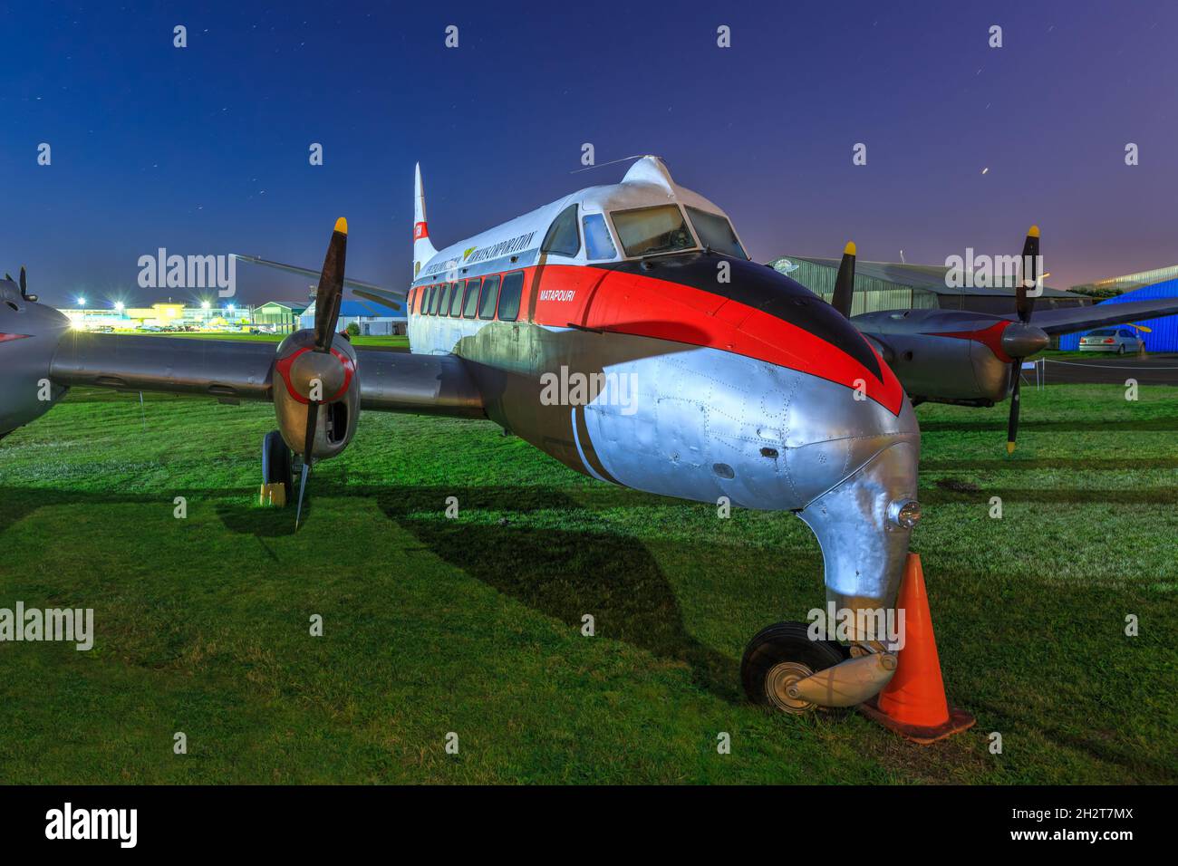 A de Havilland DH.114 Heron, a small 1950s airliner, on display under a starry night sky. This plane was flown by the New Zealand National Airways Co. Stock Photo