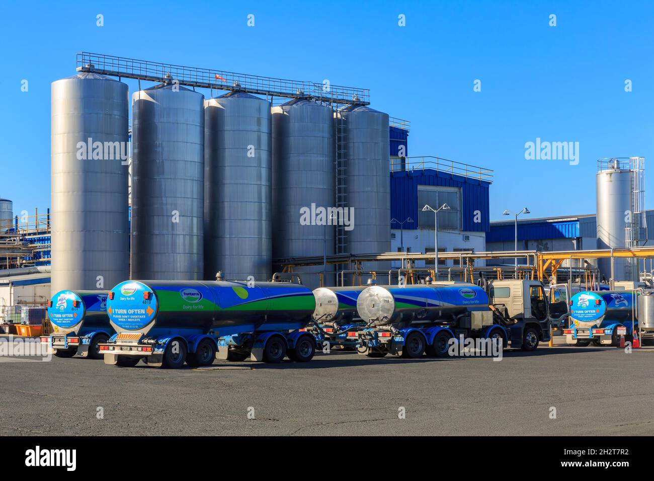 A Fonterra dairy factory with milk tankers parked outside in Tirau, New Zealand. The Fonterra dairy co-operative is New Zealand's largest company Stock Photo