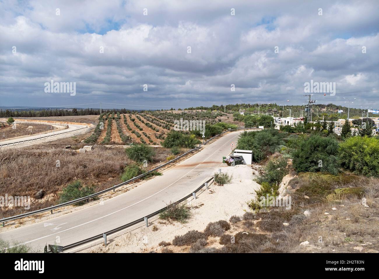 Israeli checkpoint at the entrance to the Gush Etzion region of the West Bank from the Ha-Lamad-Hey observation point with orchards in the background Stock Photo