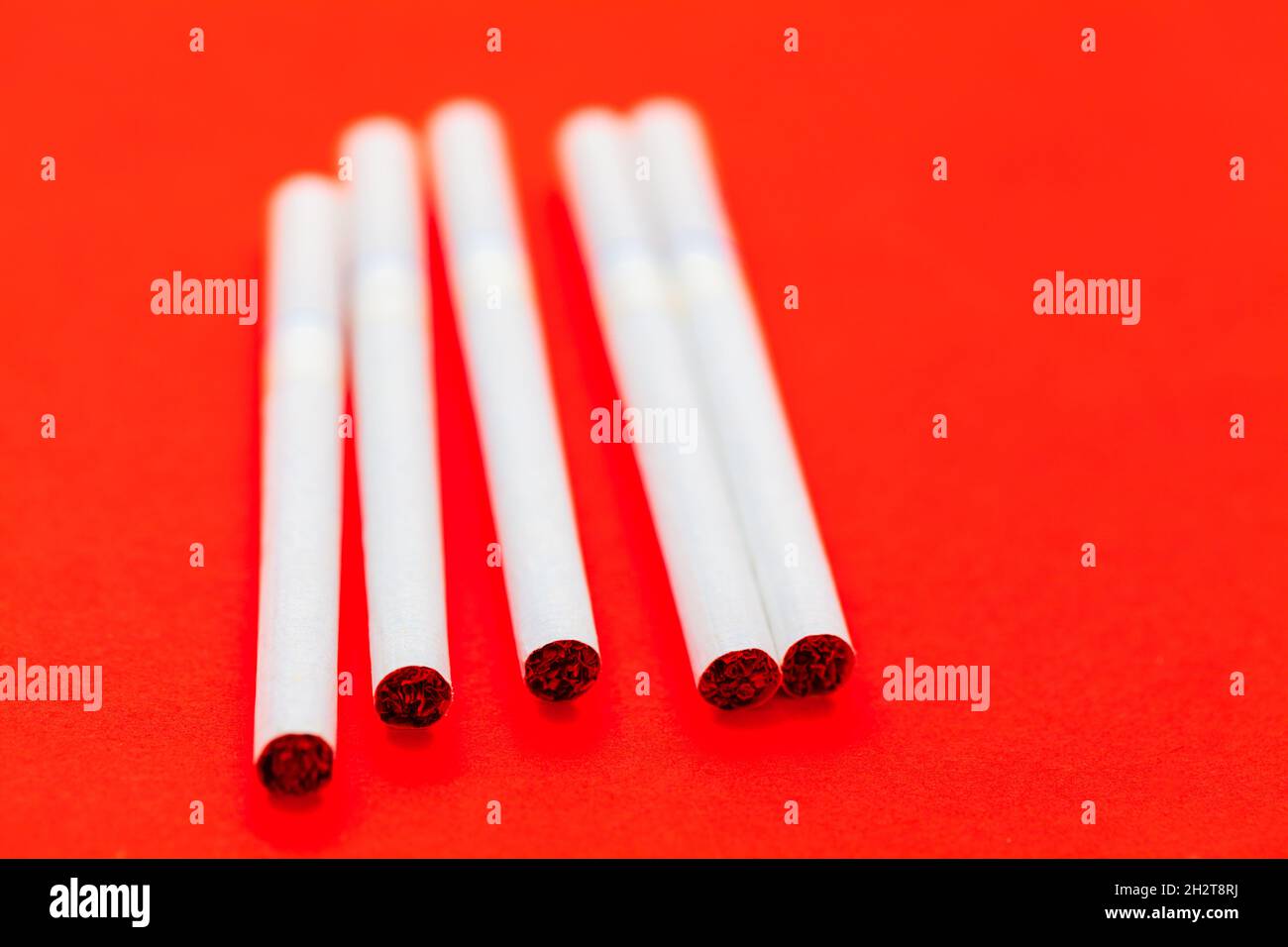Cigarettes on red background with selective focus . Tobacco shop showcase Stock Photo