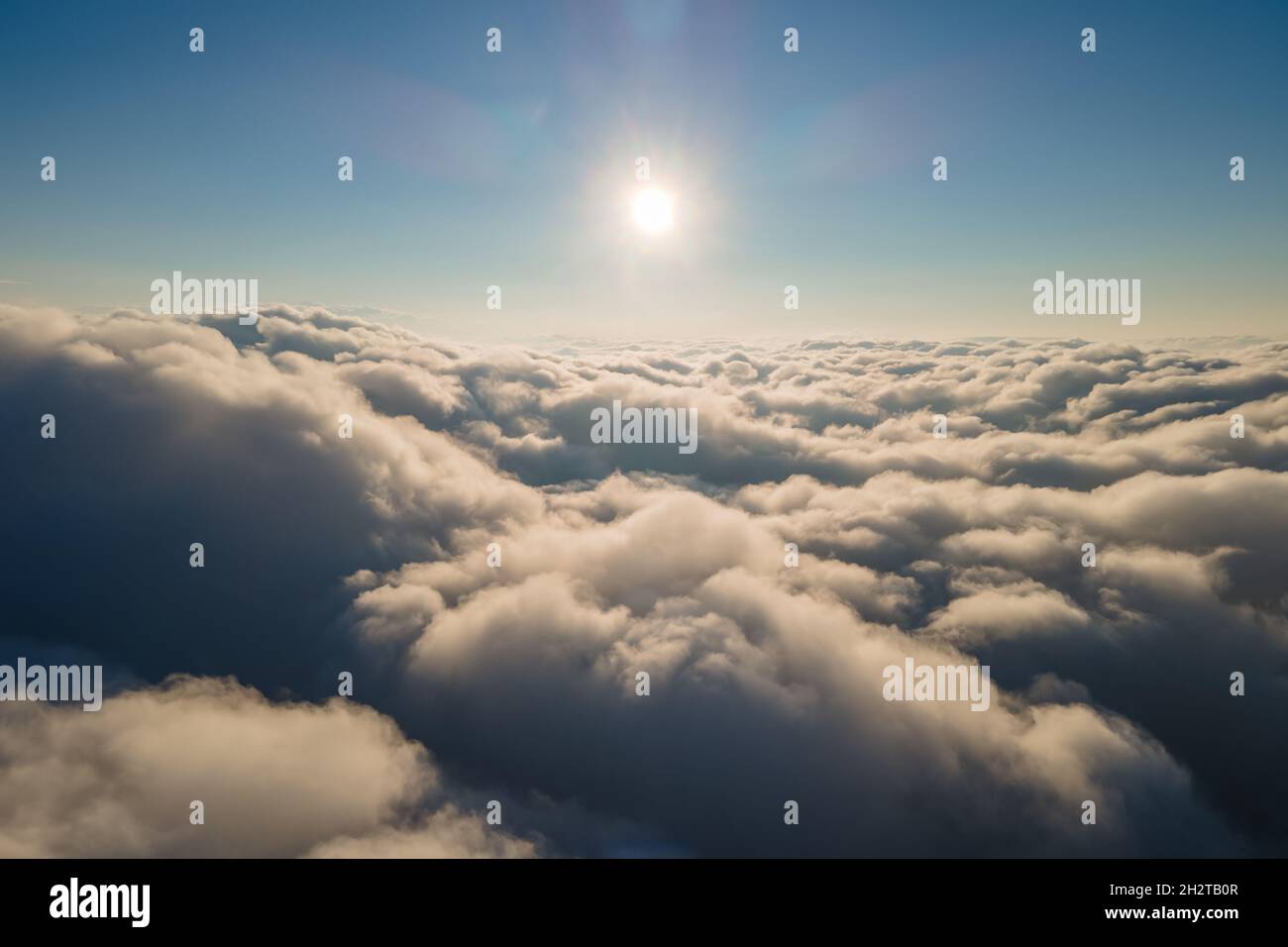 Aerial view from airplane window at high altitude of dense puffy ...