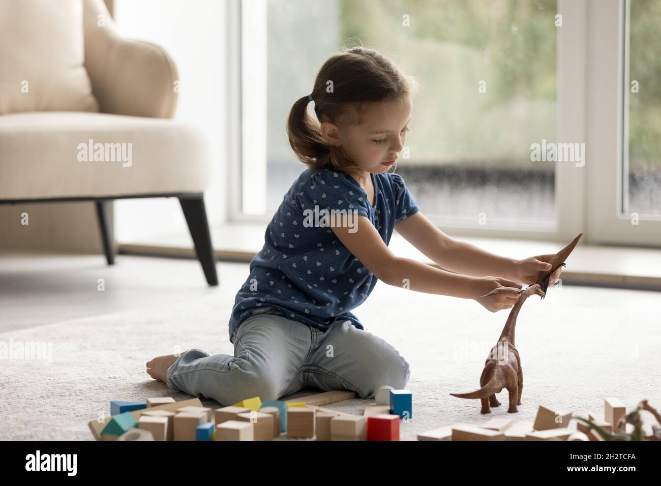 Adorable little preschool child girl playing toys Stock Photo - Alamy