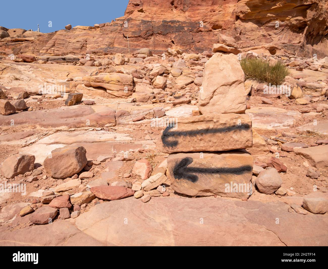 Black arrows marks or signs indicating the Al-Khubtha Trail in Petra,Jordan. Stock Photo