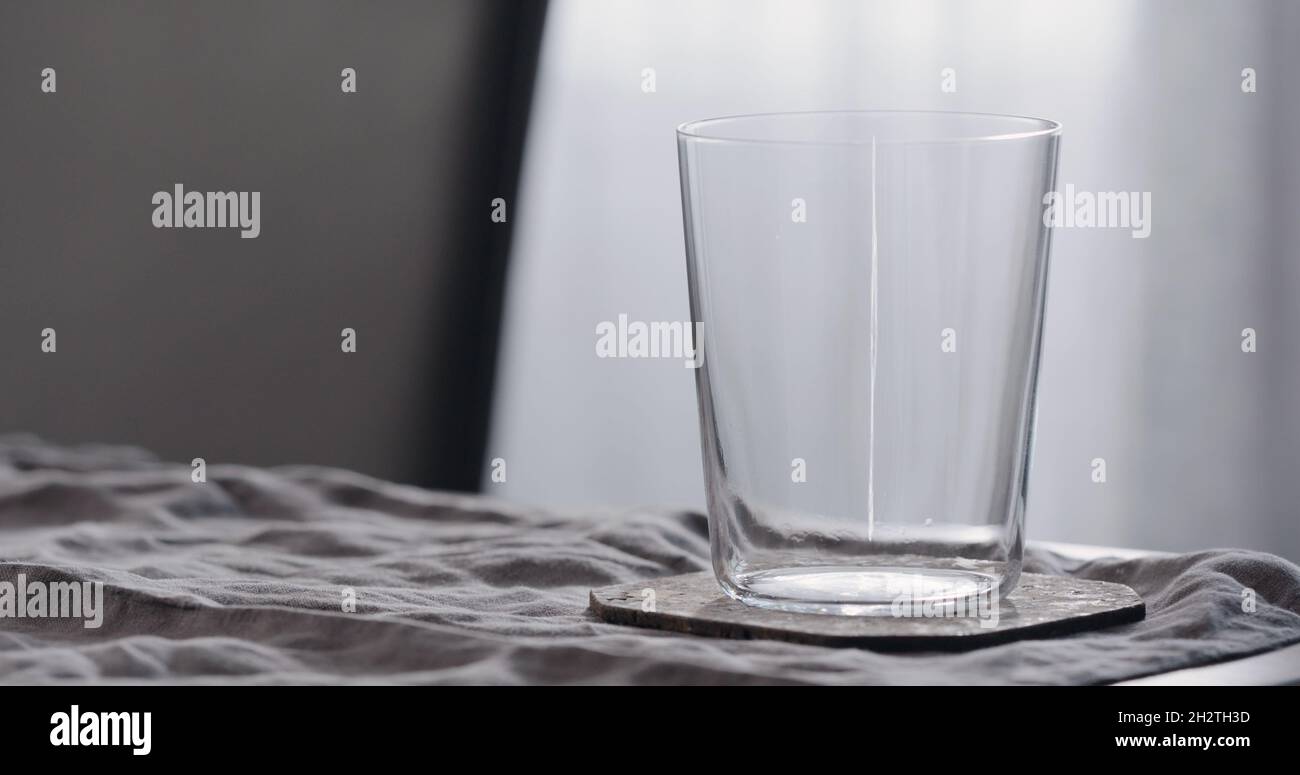 empty tumbler glass on linen cloth, wide photo Stock Photo - Alamy