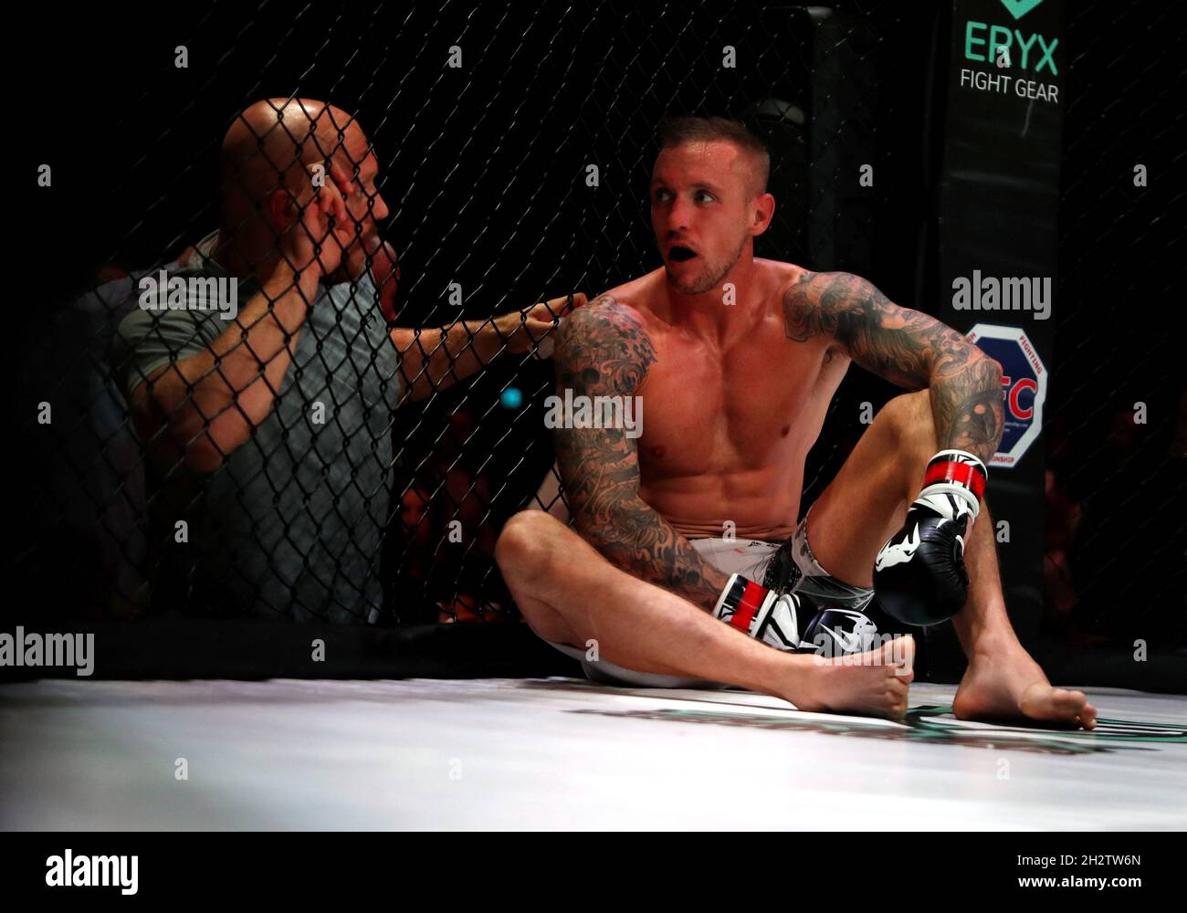 A MMA fighter sits inside the octagon during the Mixed Martial Arts (MMA)  British Fighting Championship held at the Middlesbrough Sports Village in  Middlesbrough, Britain October 23, 2021. Picture taken October 23,