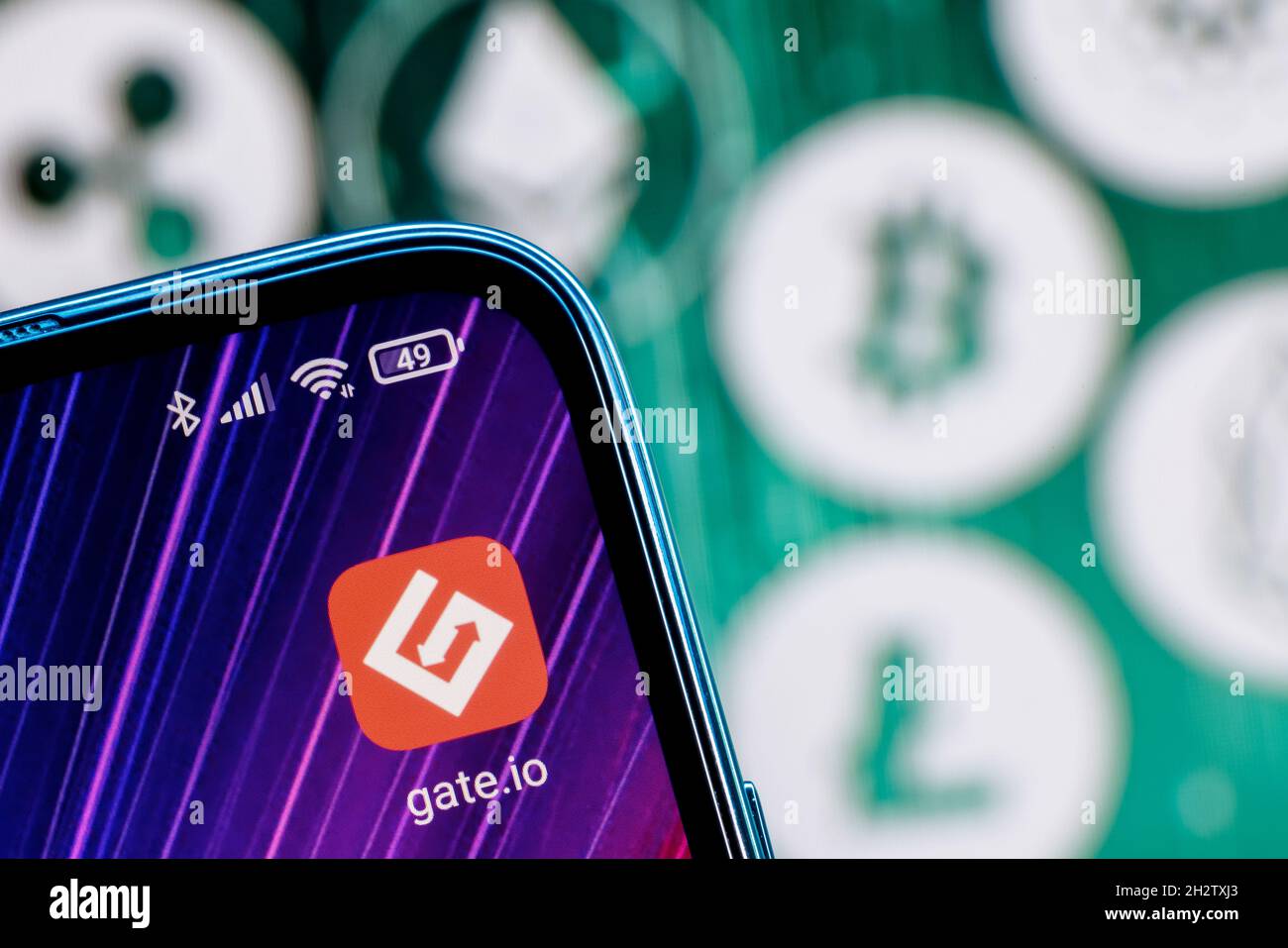 Gate.io is a cryptocurrency exchange. Gate.io app on smartphone screen  against the background of the main cryptocurrencies Stock Photo - Alamy