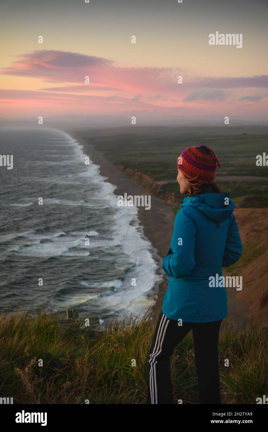 Traveler standing and looking sunset, sea and beach at Point Reyes National Seashore, California Stock Photo