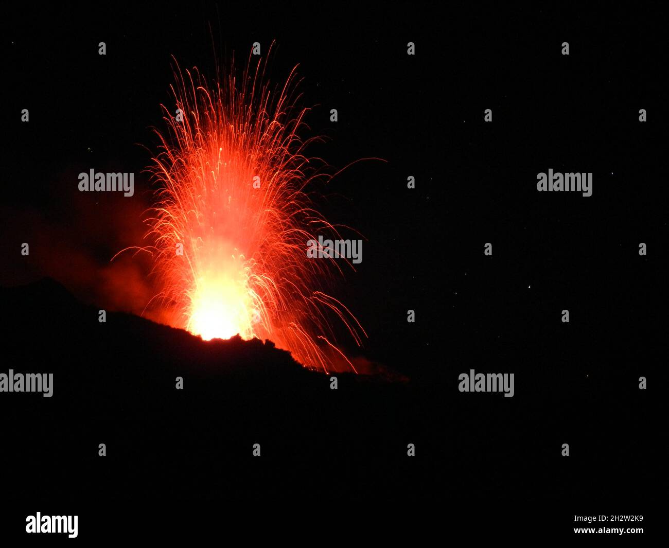 eruption of active volcano with spectacular red light traces Stock Photo