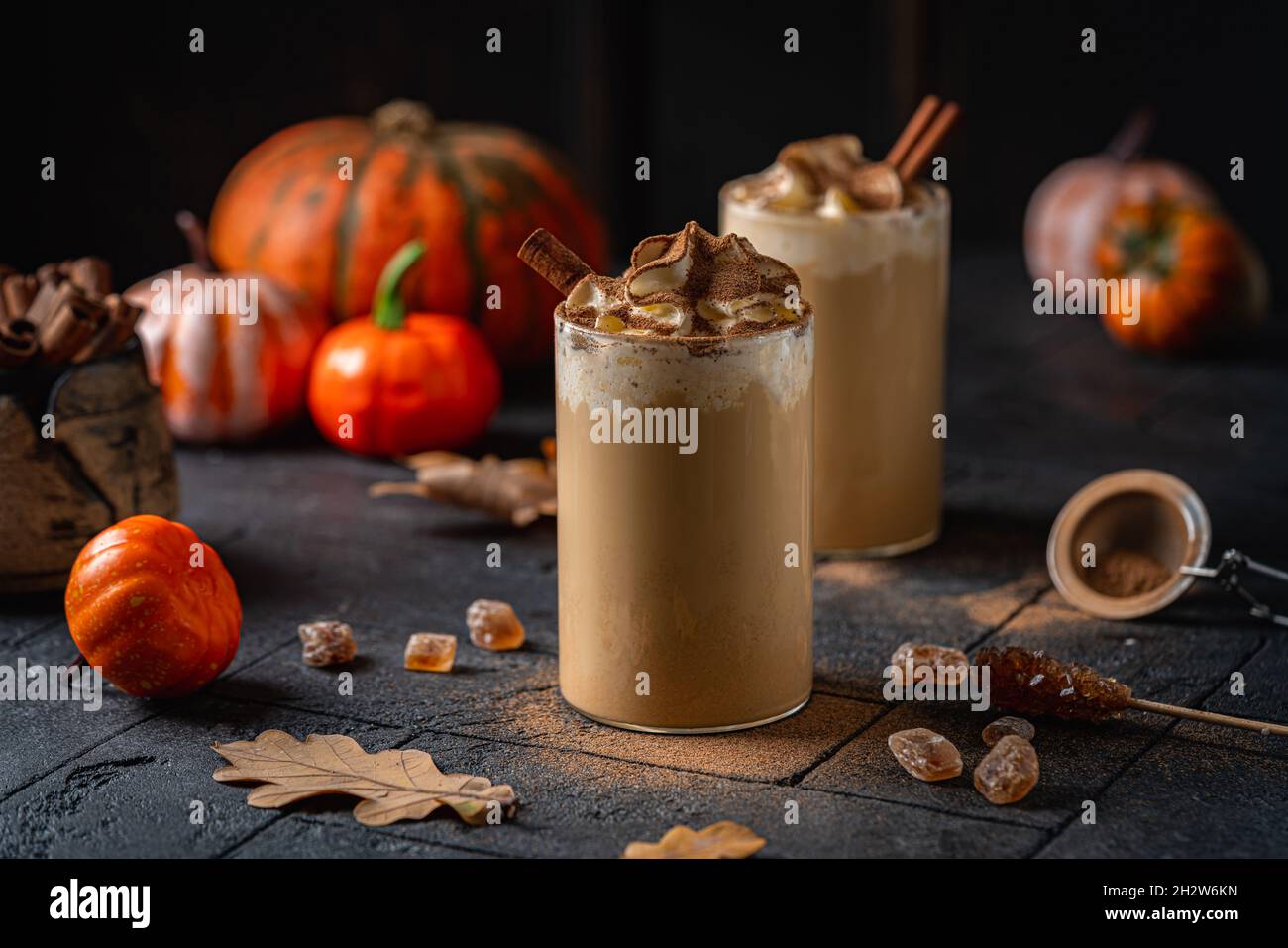 Autumn pumpkin spice latte with whipped cream and cinnamon on dark ...
