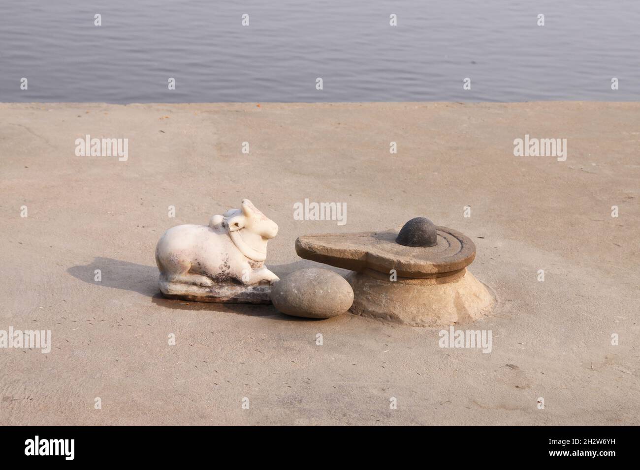 ‘Linga and Yoni’, symbolizing the Hindu god Shiva, are placed in front of the Ganges River in Varanasi. Stock Photo