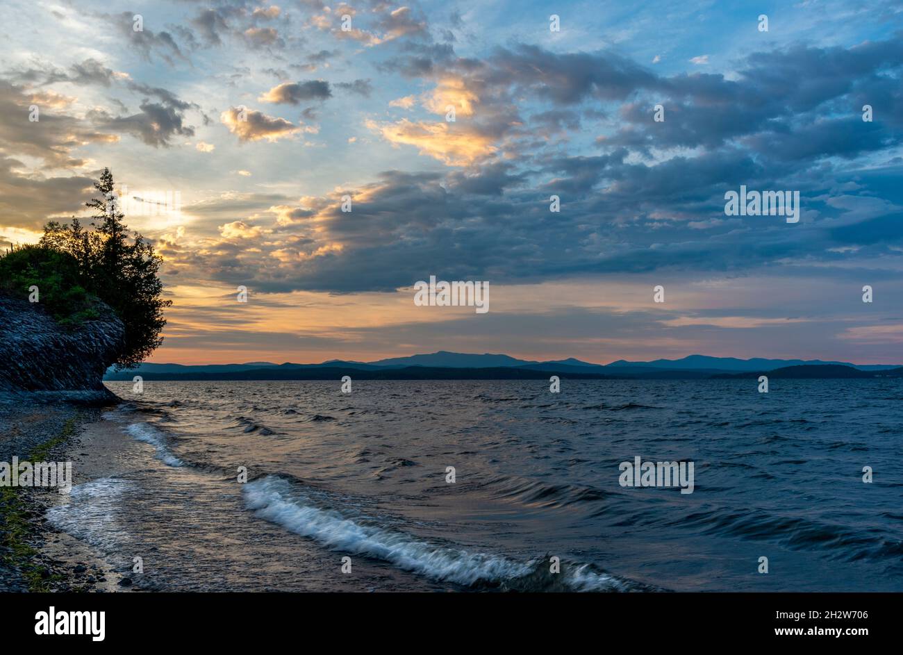 Morning view of Lake Champlain with dramatic sky and rock formations