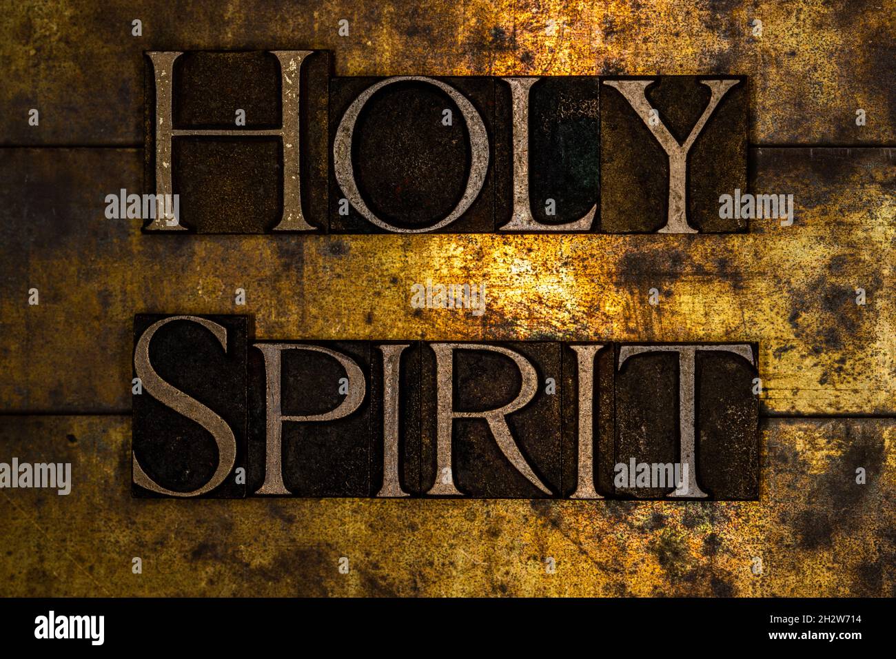 Holy Spirit text on textured grunge copper and vintage gold background Stock Photo