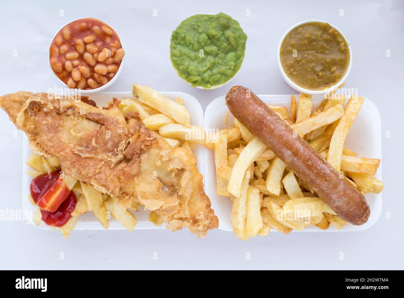 Sheffield UK – 7 Dec 2017: Traditional British fish and chips with ketchup, mushy peas or curry sauce at Kelham Fisheries Stock Photo