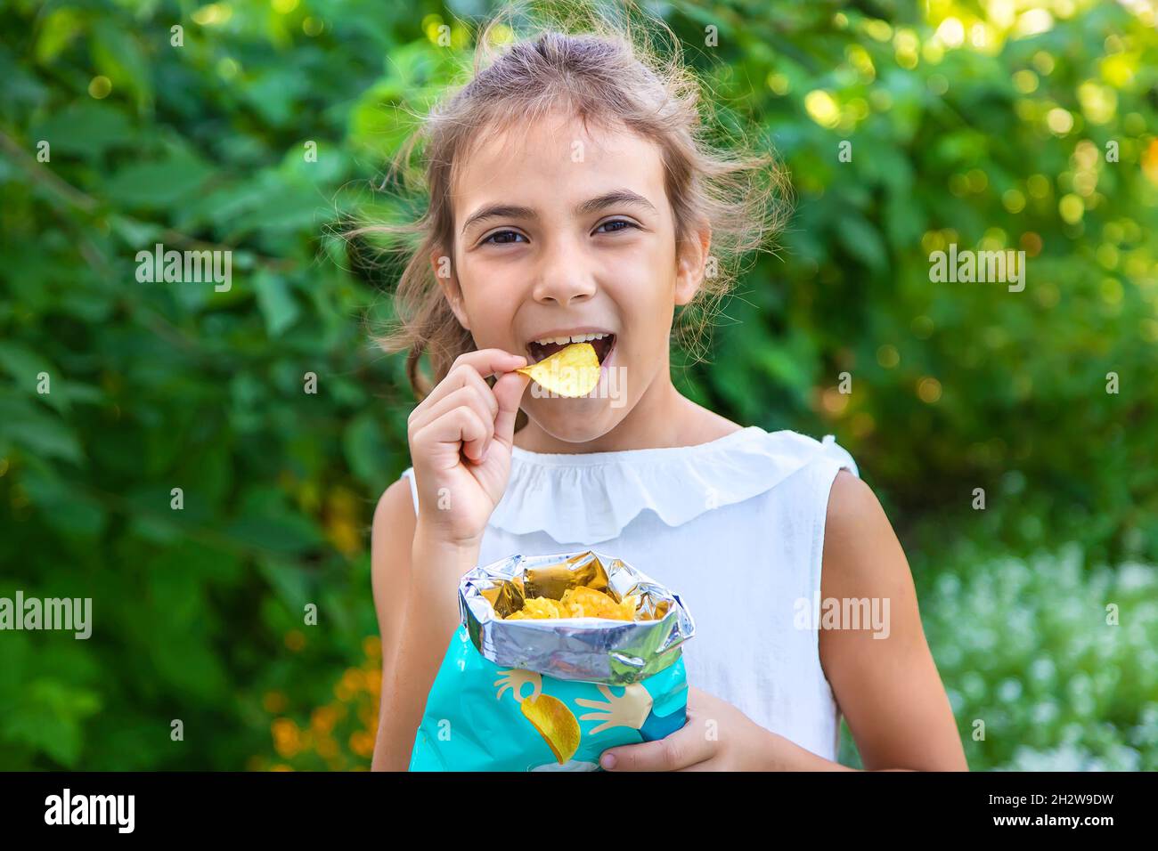 The child is eating chips. Selective focus. Kid Stock Photo Alamy