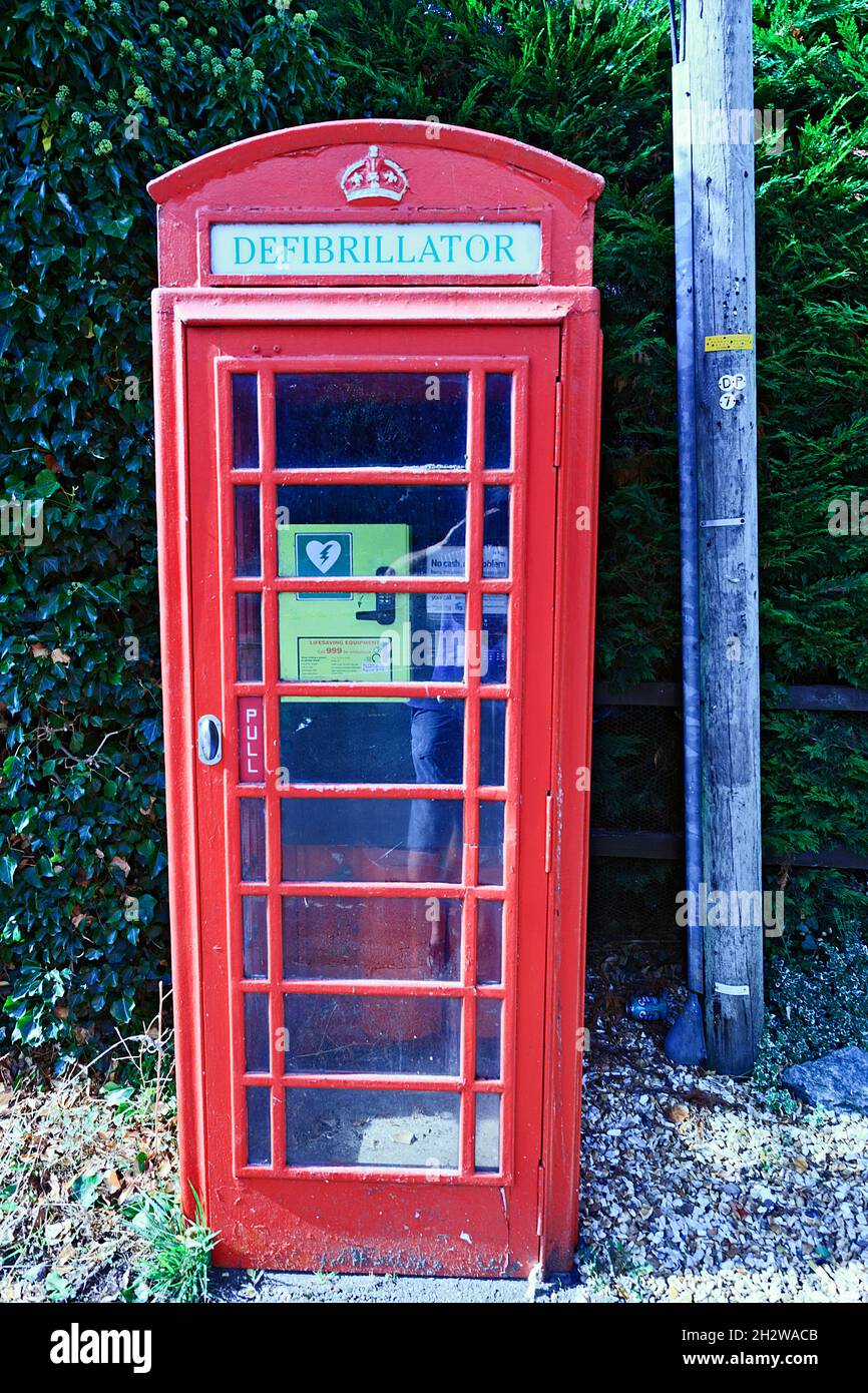 Disused telephone box used for defibrillator in Cromwell village, Nottinghamshire, England, UK Stock Photo