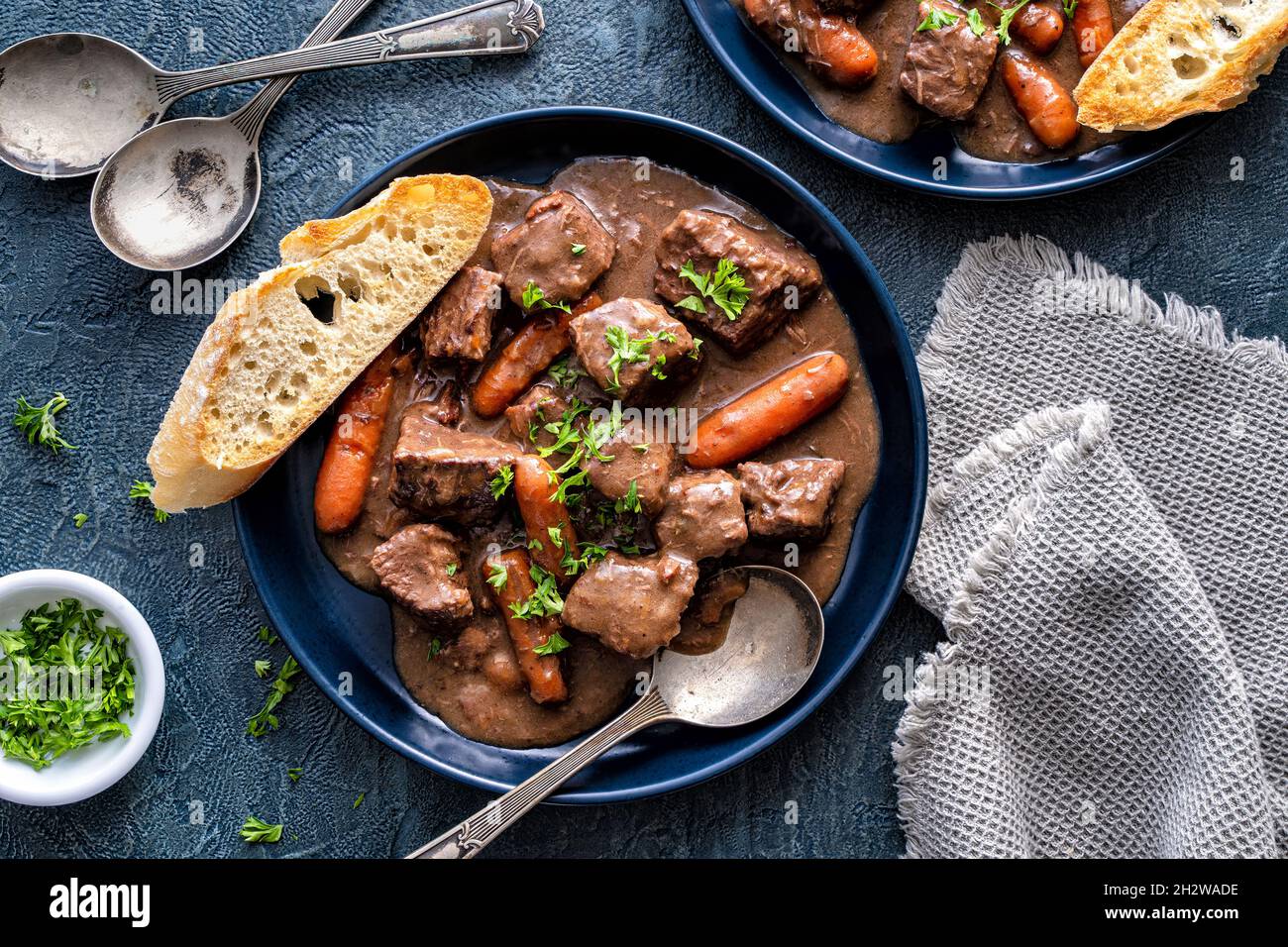 Delicious beef bourguignon stew with wine, carrots and onion garnished with parsley. Stock Photo
