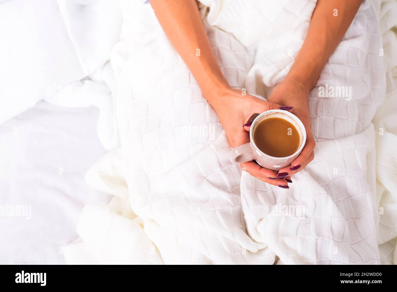 hands holding hot cup of coffee in bed Stock Photo - Alamy