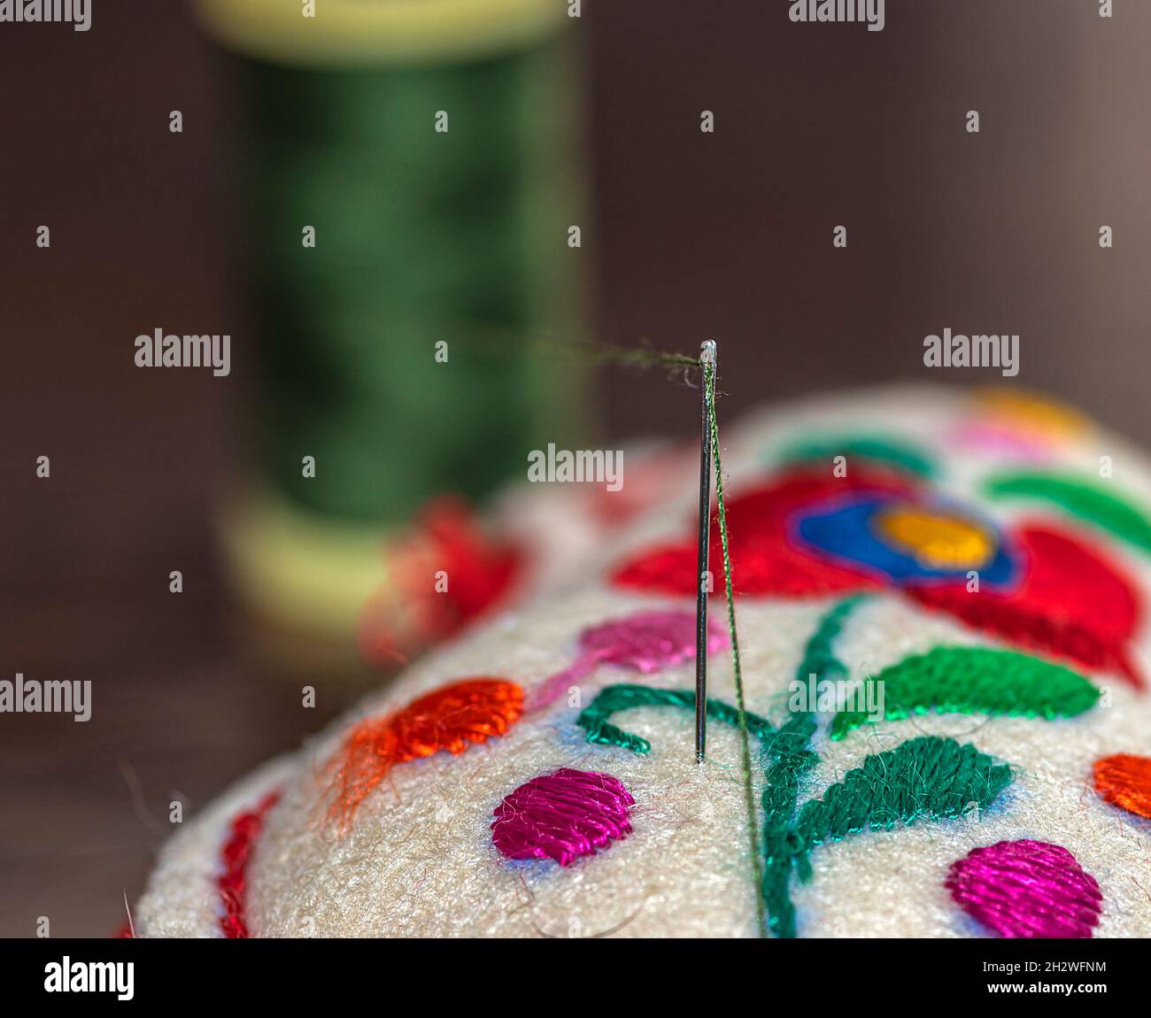 decorative needlepoint made of felt and threaded sewing needle Stock