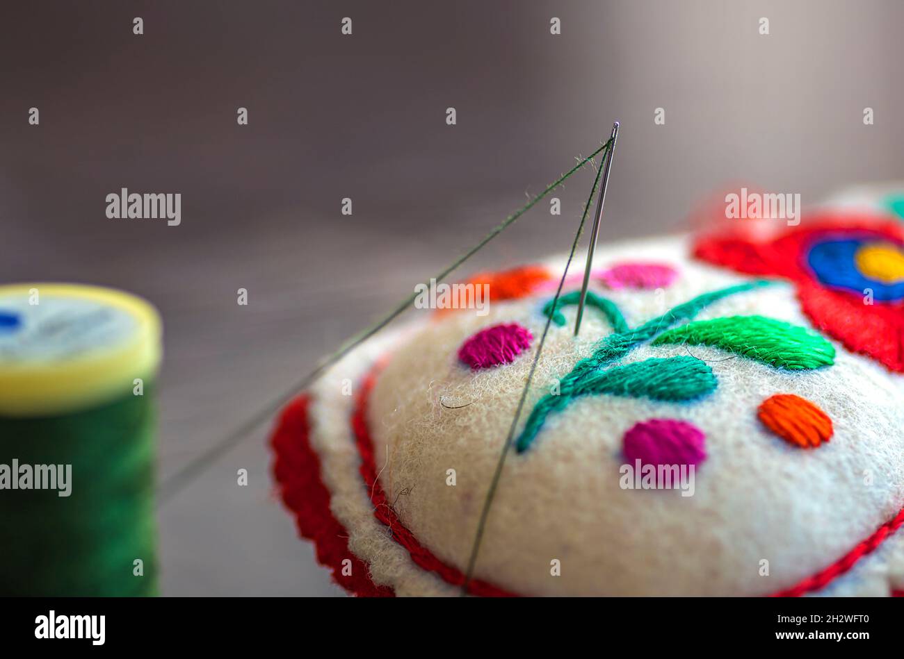 decorative needlepoint made of felt and threaded sewing needle Stock