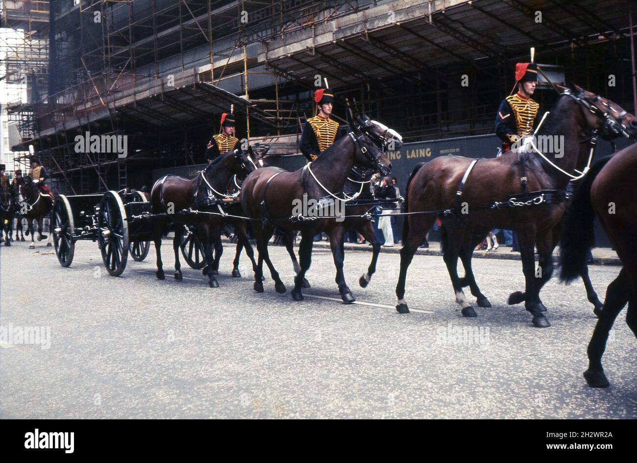 Members of the King’s Troop, Royal Horse Artillery en-route from their barracks in St. John’s Wood to Hyde Park, London in February 1977 to fire a ceremonial 21-gun Royal salute to herald the beginning of the Queen’s Silver Jubilee Year. The team of six horses, ridden by three ‘drivers’ are pulling one of the troop’s First World War-era QF 13-pounder guns and its limber. Stock Photo