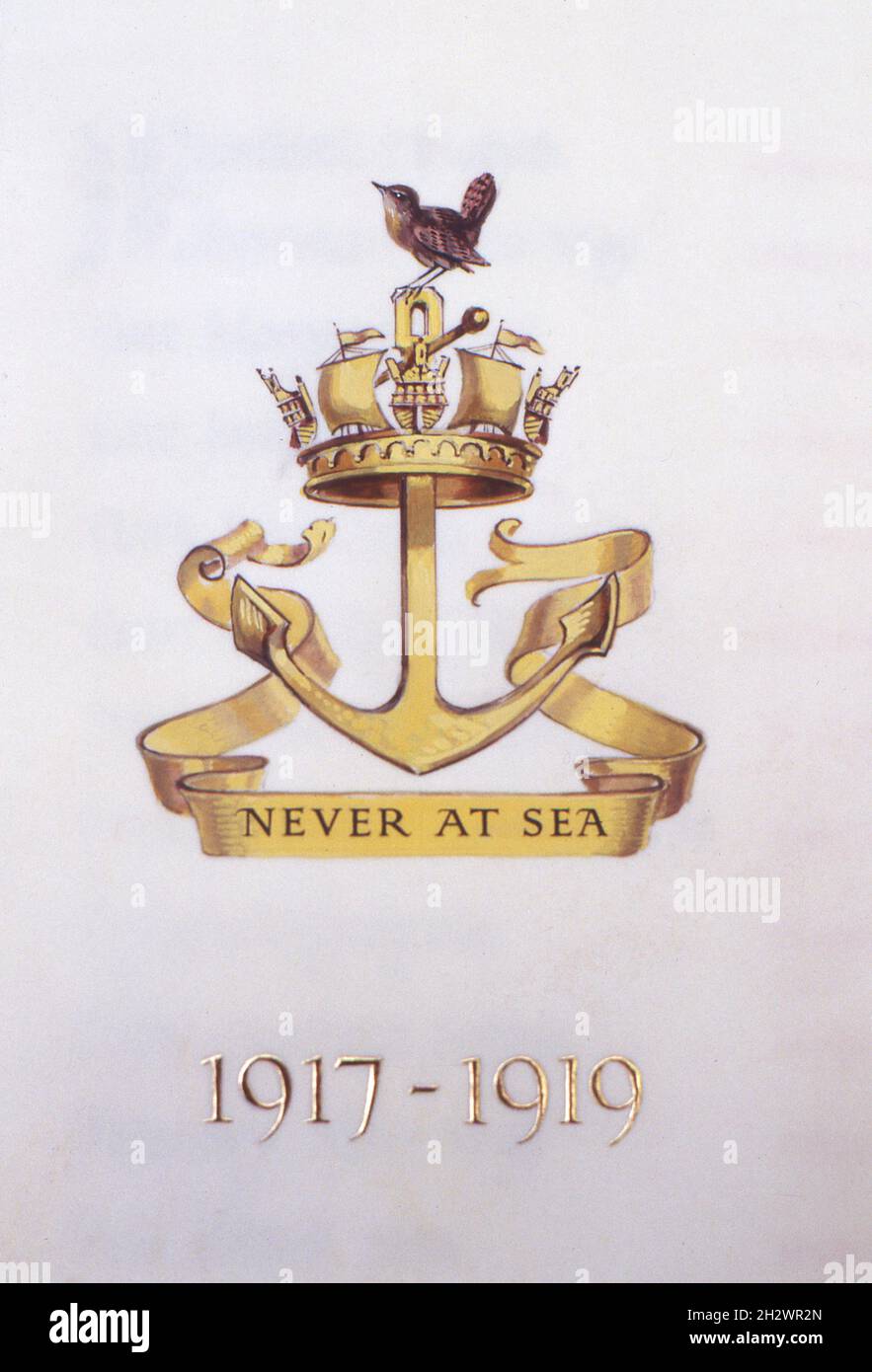A close-up detail from a page of the Women’s Royal Naval Service book of remembrance held at St Mary Le Strand, London, the official church of the Women’s Royal Naval Service, the Women’s Royal Naval Reserve and the Association of Wrens. The photograph shows a hand painted badge of the W.R.N.S., its motto “Never at Sea” and the dates 1917-1919. Taken during the 1990s. Stock Photo