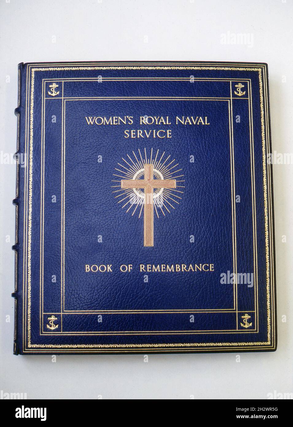 A photograph of the cover of the Women’s Royal Naval Service book of remembrance held at St Mary Le Strand, London, the official church of the Women’s Royal Naval Service, the Women’s Royal Naval Reserve and the Association of Wrens. The book is bound in blue leather and decorated with gilt tooling. Taken during the 1990s. Stock Photo