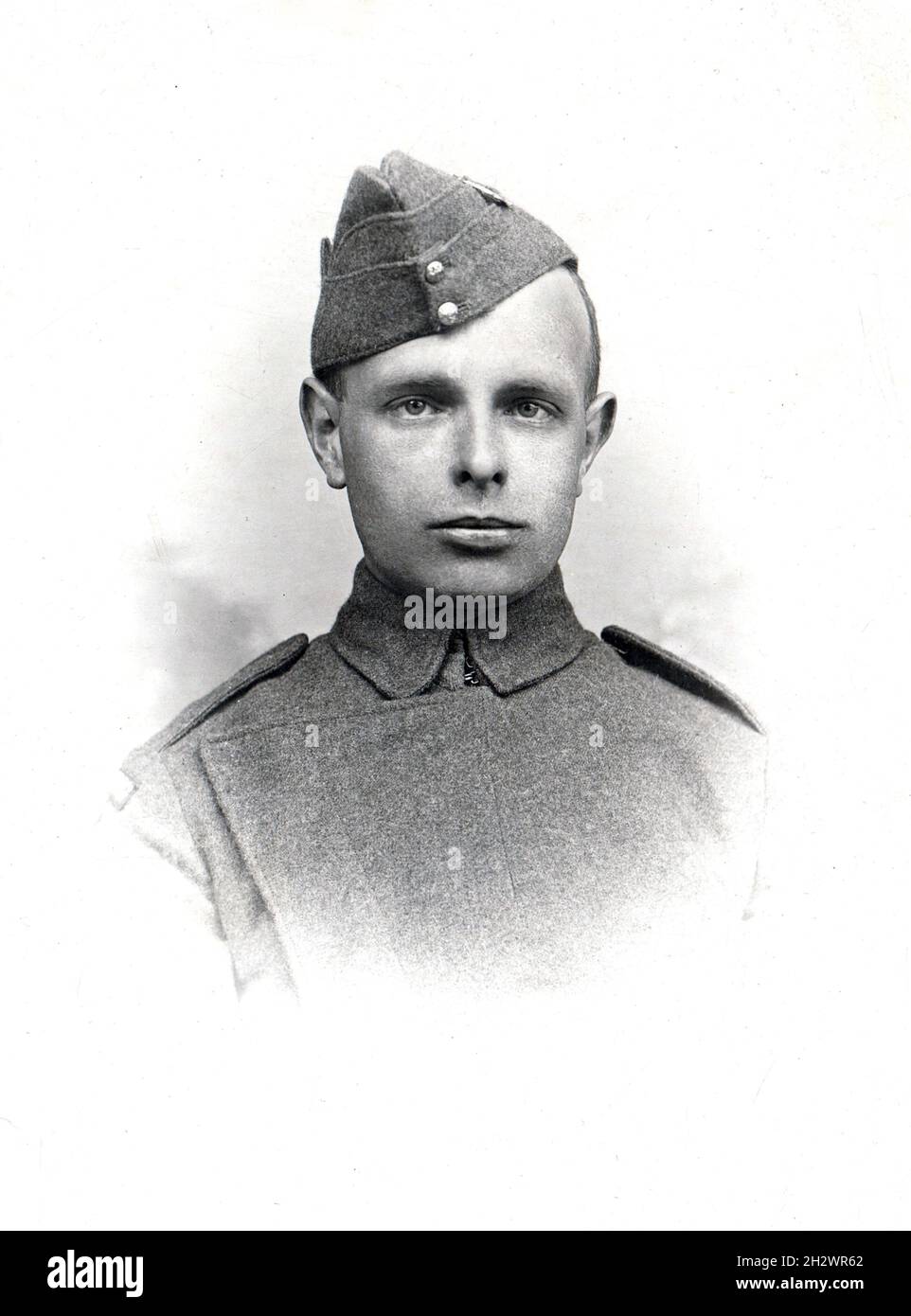 An antique black & white portrait photograph of a First World War Royal Flying Corps serviceman in uniform. He is wearing an RFC side cap and tunic, which due to its unique design was known as the ‘maternity’ pattern. Stock Photo