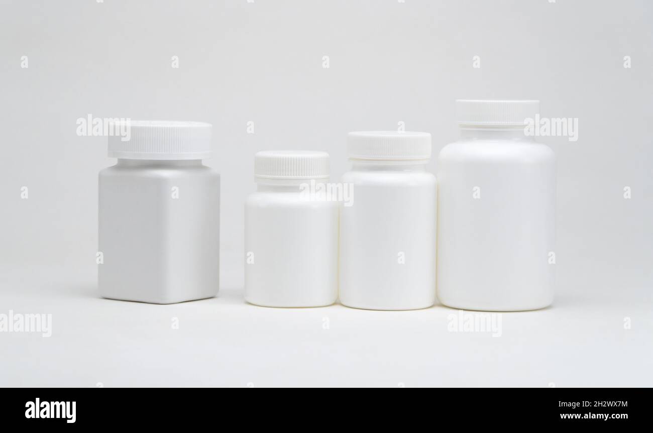 White plastic pill jars on a white background. Isolated Stock Photo