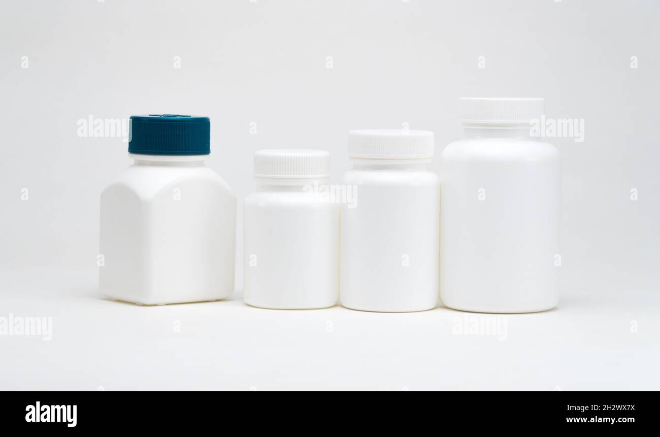 White plastic pill jars on a white background. Isolated Stock Photo